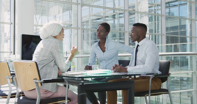 Diverse business team meeting in modern office building - Download Free Stock Images Pikwizard.com