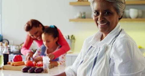 Elderly Woman Cooking at Home with Family in Kitchen - Download Free Stock Images Pikwizard.com