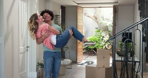 Joyful couple celebrating moving into new home together