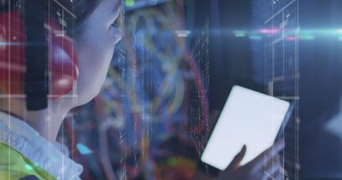Woman technician using tablet in high-tech server room