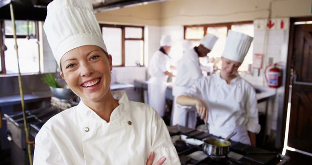 Use this image to depict professional kitchen environments, teamwork in culinary settings, or promoting culinary schools and chef training programs. Ideal for illustrating topics about professional gastronomy, behind-the-scenes at restaurants, and chef lifestyle.