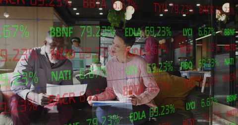 Diverse Colleagues Analyzing Financial Stocks in Modern Office