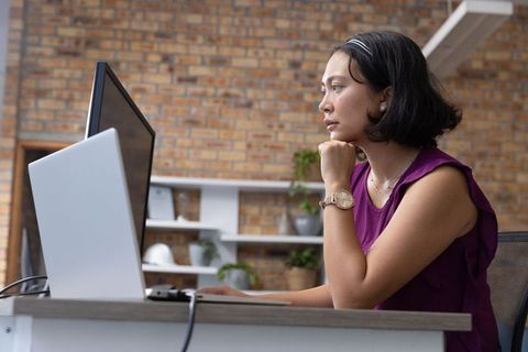 Focused Businesswoman Working at Modern Office Desk with Technology Inspiration
