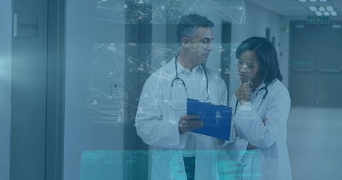 Innovative Doctors Analyzing Digital Medical Data in Hospital Corridor