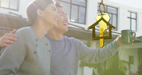 Happy biracial couple celebrating new home ownership