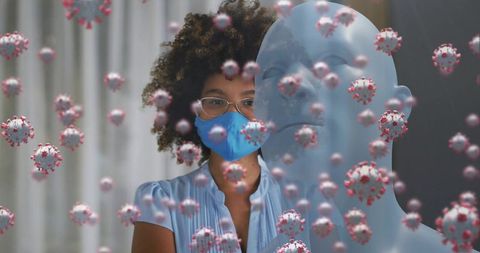 Woman Wearing Blue Mask Facing Floating Coronavirus Particles with Translucent Mannequin
