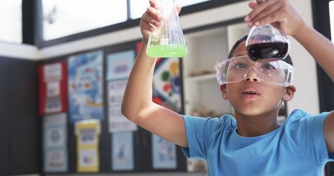 Curious Student Analyzing Colorful Chemical Reactions in Classroom