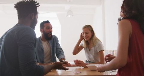 Diverse Friends Engaging in Fun Card Game Together at Home