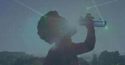 Silhouette of Athlete Drinking Water Amid Digital Connections