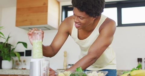 Smiling Man Making Green Smoothie, Embracing Healthy Lifestyle