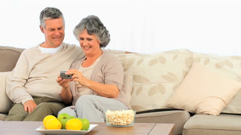 Joyful Senior Couple Viewing Photos at Home