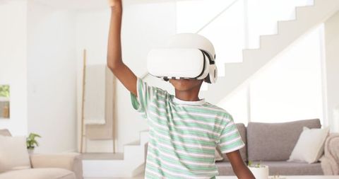 Youth Exploring Virtual Reality in Bright Living Room Wearing White VR Headset