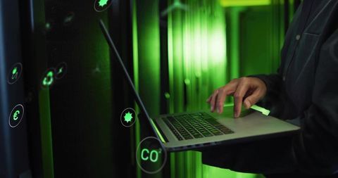 IT Technician Utilizing Laptop in Futuristic Data Center