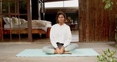 Woman Meditating on Outdoor Patio Promoting Mindfulness and Relaxation