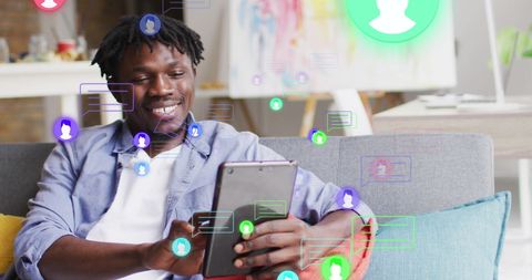 Joyful African American Man Interacting with Tablet and Social Icons