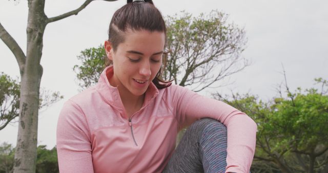 Young Woman Preparing for Outdoor Workout in Park - Download Free Stock Images Pikwizard.com