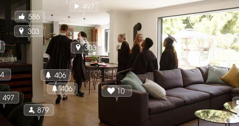 Graduates celebrating at home wearing gowns and mortarboards with social media notifications