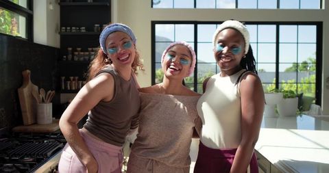 African american friends enjoying home spa morning with under-eye patches and loungewear