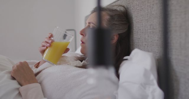 Woman Lying in Bed and Drinking Orange Juice - Download Free Stock Images Pikwizard.com