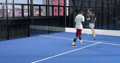 Diverse Friends Playing Padel on Urban Blue Turf Court