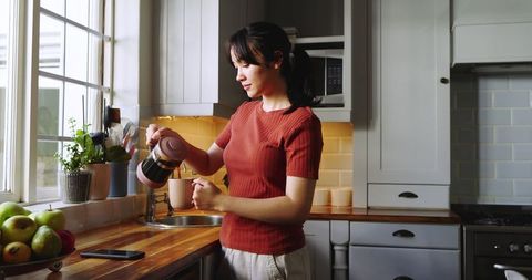 Woman Pouring Coffee in Cozy Kitchen Morning Routine