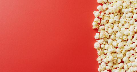 Close-up of popcorn on vibrant red background