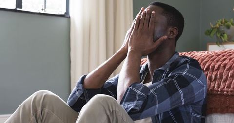 Stressed Man with Closed Eyes Relaxing at Home