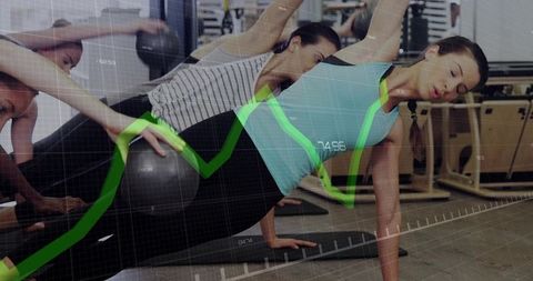 Group Performing Side-Plank Holding Medicine Ball Core Workout in Fitness Studio with Green Data Ove