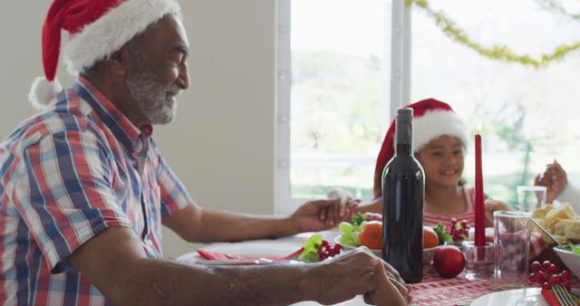 Grandfather and Granddaughter Celebrating Christmas at Festive Dinner Table - Download Free Stock Images Pikwizard.com