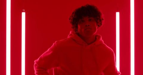 Dramatic Portrait of a Man in Neon Red Light with Minimalist Style