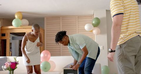 Friends decorating for celebration with balloons and flowers