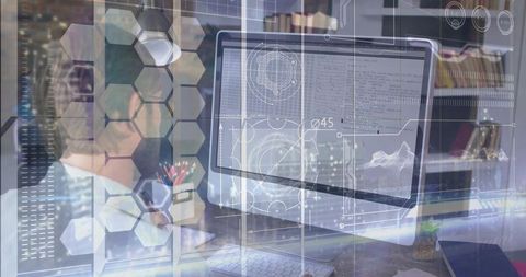 Developer reviewing code on desktop monitor with futuristic hud overlay and hexagonal ui