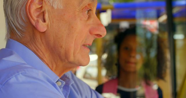 Elderly Man Conversing with Young Girl Outdoors - Download Free Stock Images Pikwizard.com