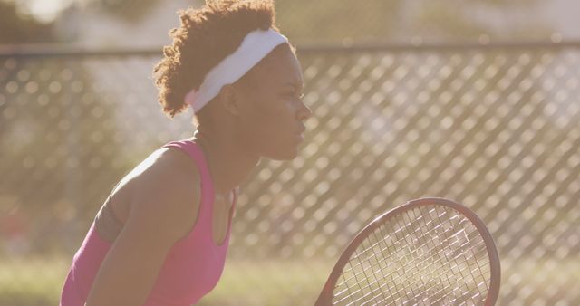 Determined Female Tennis Player Waiting for Serve in Sunlight - Download Free Stock Images Pikwizard.com