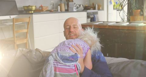 Happy Father Holding Daughter in Cozy Living Room