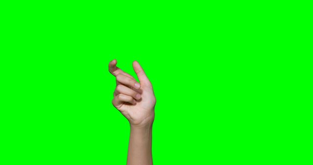 Hand snapping fingers against green screen background ideal for video editing, creating special effects, teaching gesture communication. Useful for presentations, advertisements, tutorials, instructional videos.