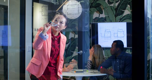 Businesswoman Drawing on Glass Board in Office Meeting Room - Download Free Stock Images Pikwizard.com