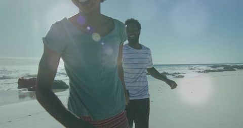 Carefree Couple Enjoying Leisurely Walk on Sunny Beach