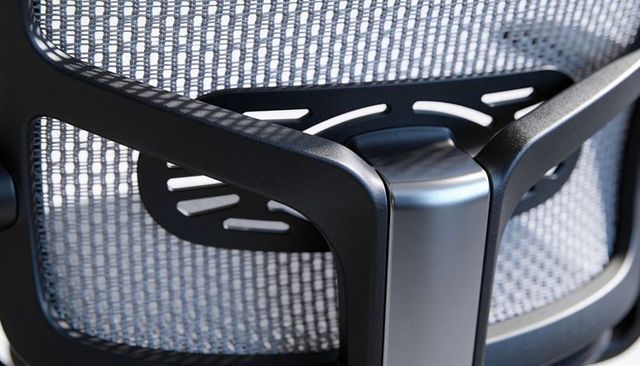 Ergonomic mesh chair back highlighting lumbar support and silver spine closeup office design
