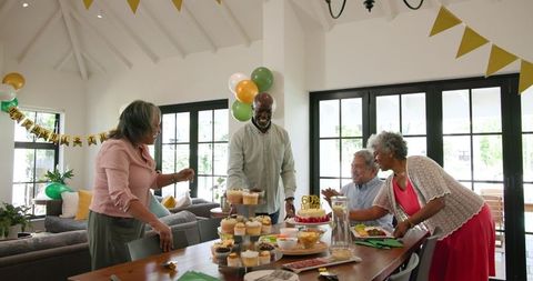 Senior Friends Celebrating Birthday Party Joyfully Together