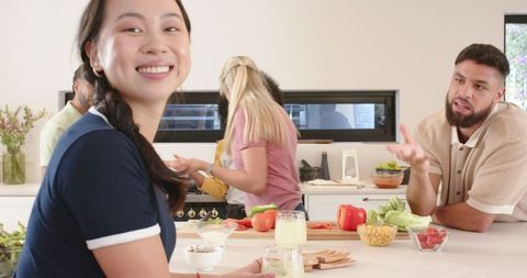 Diverse Friends Enjoying Drinks in Modern Kitchen