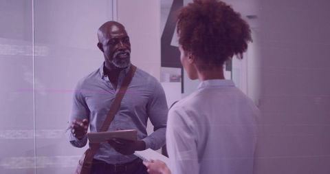 Professionals Engaging in Office Corridor Consultation