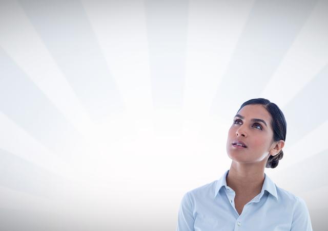 This image features a professional businesswoman looking up thoughtfully against a bright, radial background. Ideal for use in articles and presentations related to business strategy, innovative thinking, career growth, and visionary planning. Perfect for illustrating themes of contemplation, confidence, and forward thinking.