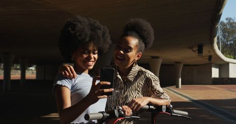 Happy Twins Enjoying Outdoor Adventure with Scooters