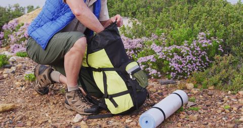 Senior Man Exploring with Backpack on Mountain Hike
