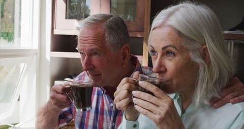Senior Couple Enjoying Coffee in Cozy Home Kitchen