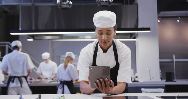 Female Chef Using Digital Tablet in Modern Kitchen - Download Free Stock Images Pikwizard.com