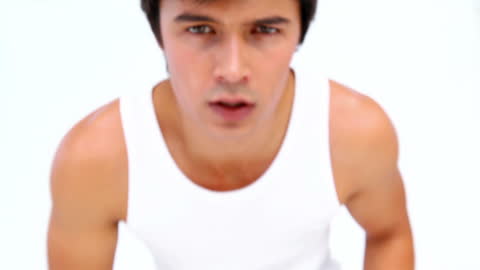 Athletic Man Engaging in Intense Kickboxing Session