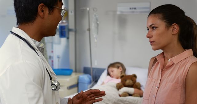 Doctor Consulting Concerned Mother in Hospital Room with Child - Download Free Stock Images Pikwizard.com