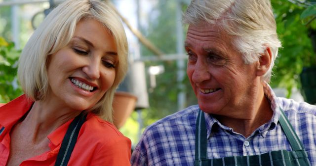 Happy mature couple in greenhouse